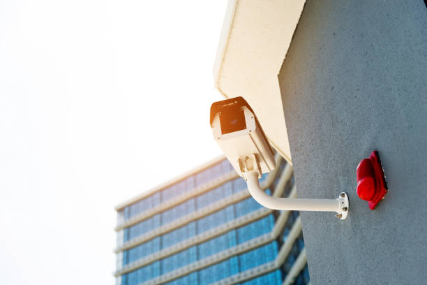 istock Security camera on the wall of office building 1085151674