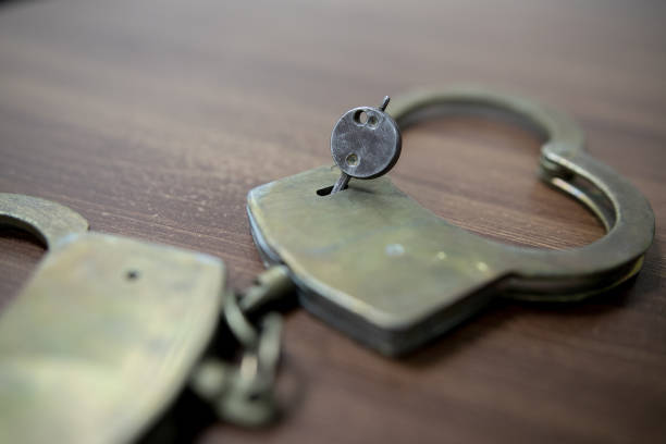 istock Selective focus on handcuffs on a keyboard cyber crime, hacking, bullying Against law concept in dark low key tone 1085161692