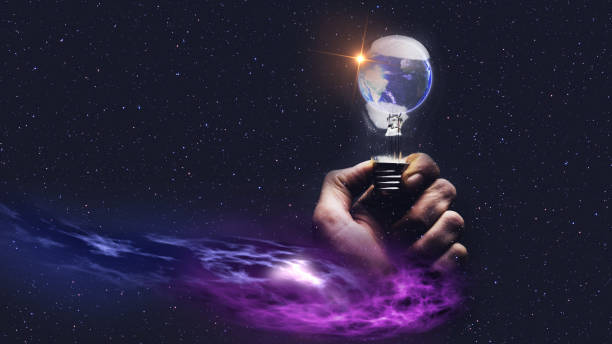 istock Image of human hand holding light bulb with earth planet inside and sunshine. Mixed media. 1085162328