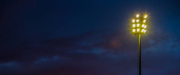 istock Bright sports stadium lights on a cloudy evening 1085165030