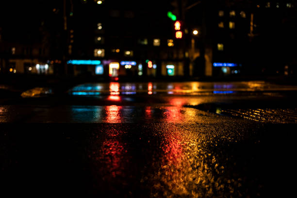 istock Urban night scene with tarmac ground light reflections 1085173008