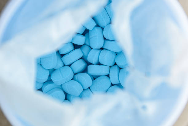 istock blue pills, pain killer in the bottle. 1085179706