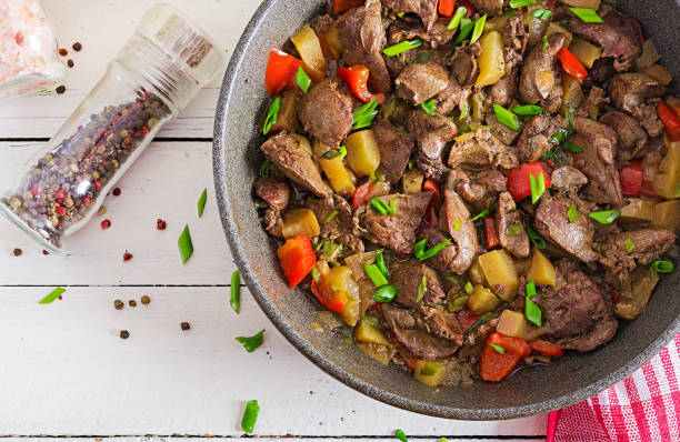 istock Fried chicken liver with apples and paprika in pan. Top view 1085181016
