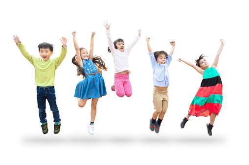 happy kids jumping in air over white background