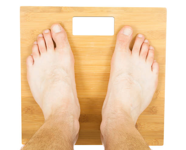 istock man feet on the scale. isolated 1085192050