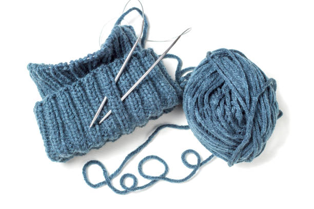 istock Knitted hat, knitting needles and skein on a white background 1085194216