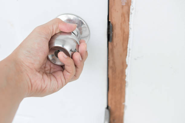 istock Hand holding a door knob on a white door 1085194374