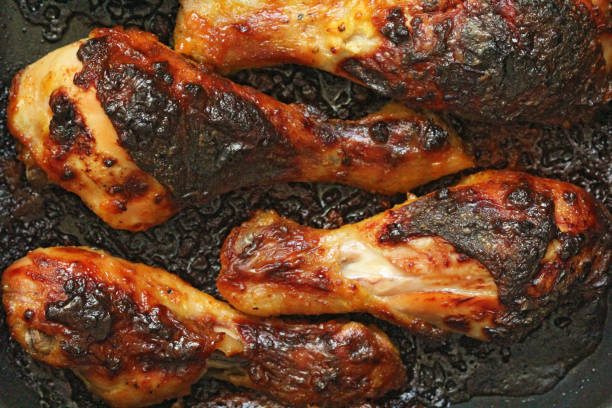 istock Grilled chicken legs with spices and garlic. Crispy fried chicken. Top view 1085194944