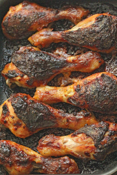 istock Grilled chicken legs with spices and garlic. Crispy fried chicken. Top view 1085194950