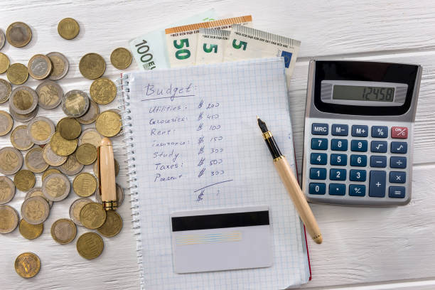 istock Euro banknotes and coins with notepad and calculator 1085197602