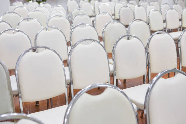 istock White chairs arranged in a seminar room 1085197620