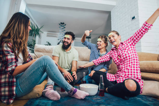 istock Happy friends playing game guess who and having fun at home 1085199546