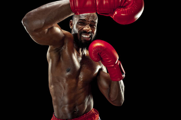 istock Hand of boxer over black background. Strength, attack and motion concept 1085200236
