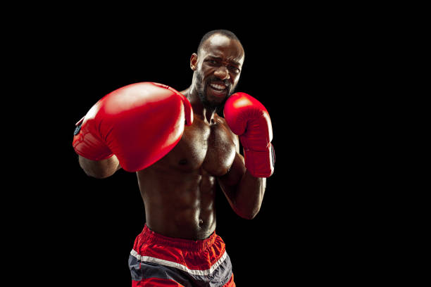istock Hand of boxer over black background. Strength, attack and motion concept 1085200274