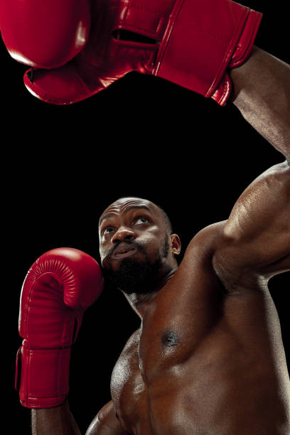 istock Hand of boxer over black background. Strength, attack and motion concept 1085200280
