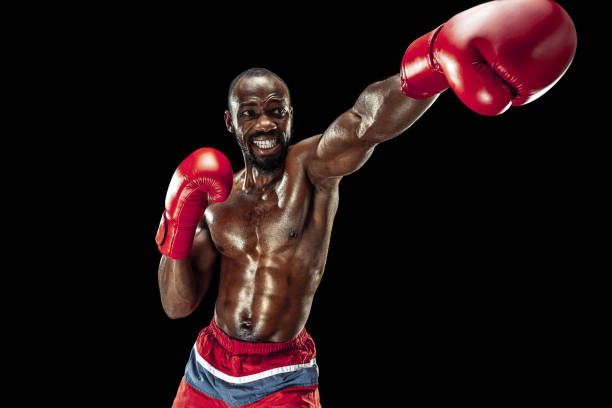 istock Hand of boxer over black background. Strength, attack and motion concept 1085200314