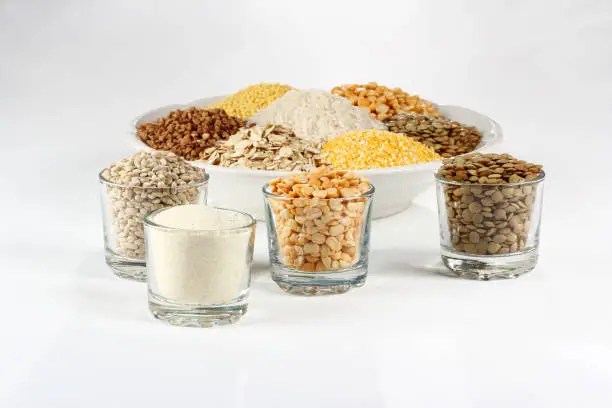 Selection various types cereal grains groats in bowl on white background.