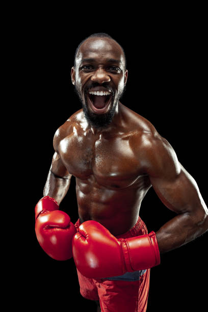 istock Hand of boxer over black background. Strength, attack and motion concept 1085200350