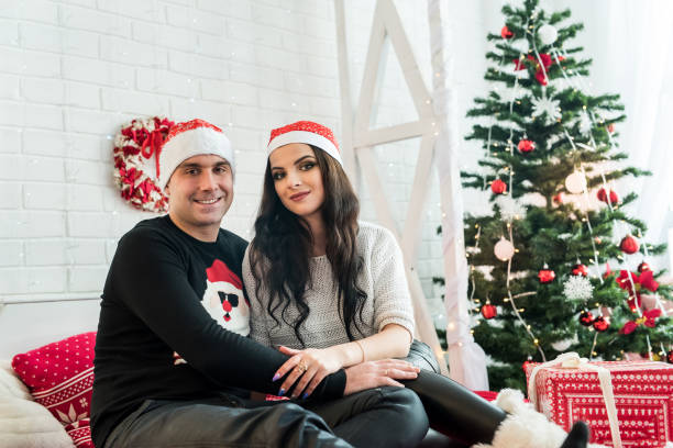istock Couple with fir tree at christmas studio 1085202434