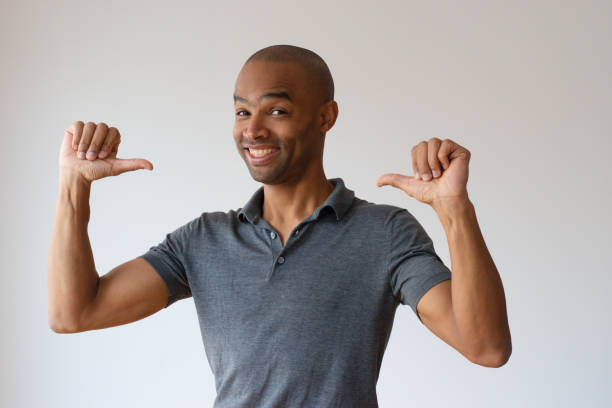 Cheerful Afro American guy proud of himself
