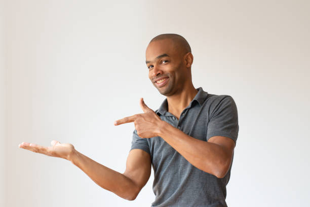 istock Cheerful dark skinned guy presenting good news 1085204622