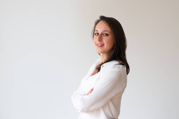 istock Smiling confident girl in white shirt posing 1085204768