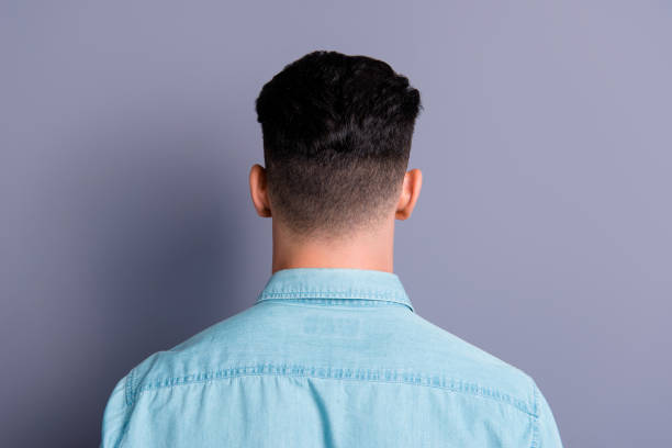 istock Rear back view of attractive handsome man wearing blue formal sh 1085208064