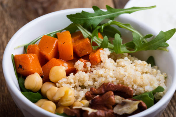 istock Healthy salad bowl with baked pumpkin, chickpeas, quinoa, arugula, walnuts 1085208722