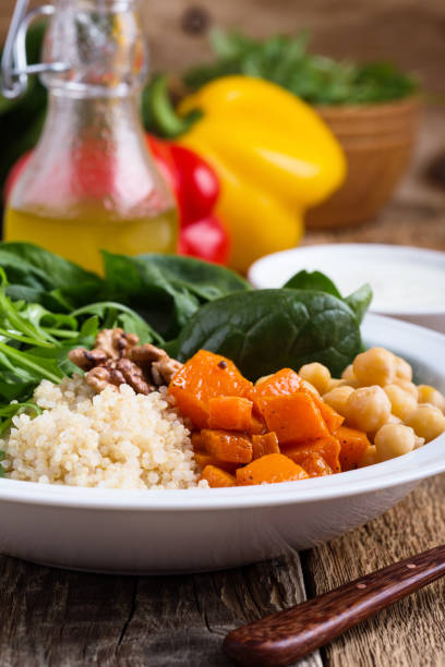 istock Healthy salad bowl with baked pumpkin,  chickpeas, quinoa, arugula, walnuts 1085208952