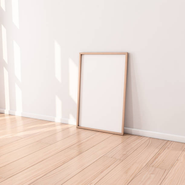 istock Poster with Wooden Frame Mockup standing on the floor in empty room 1085211504