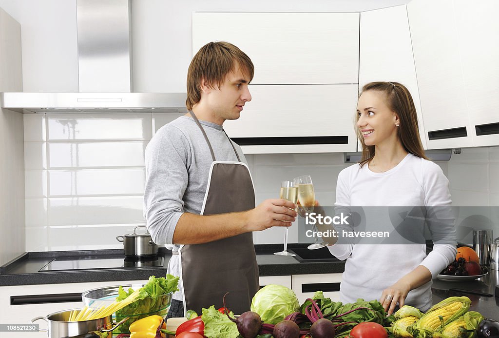 Couple cooking Couple cooking in modern kitchen Adult Stock Photo