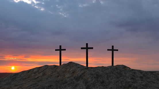 three crosses on top of a hill at sunset