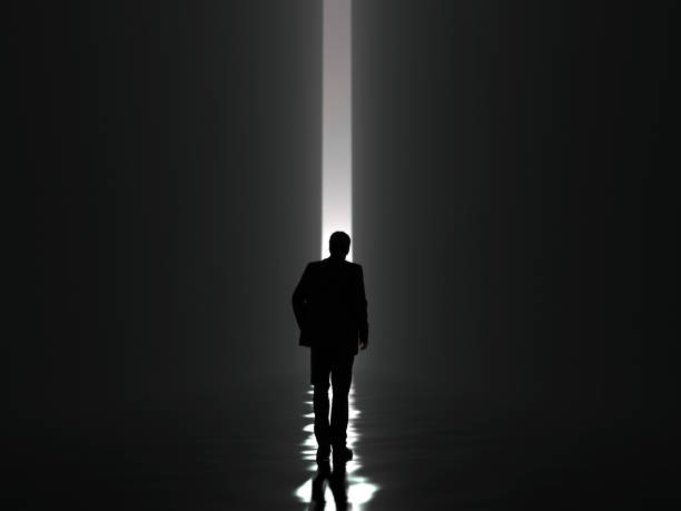 istock businessman walking towards the light 1085216068