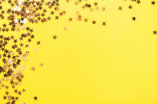 istock Golden shining stars on yellow 1085220686