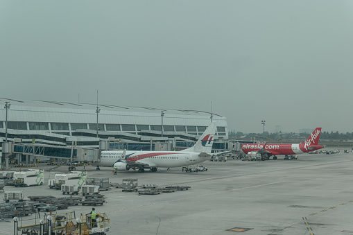 Jakarta, Indonesia - December 5, 2018: Malaysian Airline Boeing 737 and Air Asia Airbus A320 at Soekarno Hatta International Airport.