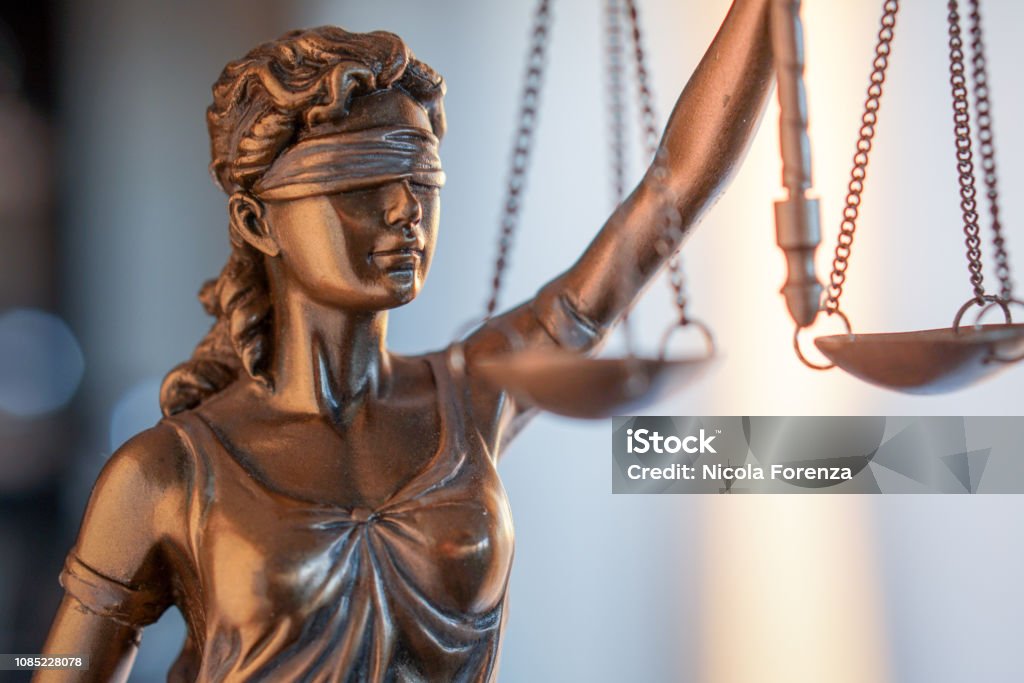 Statue of Justice with scales in lawyer office. Legal law, advice and justice concept Justice - Concept Stock Photo