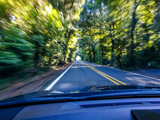 istock Car driving fast into autumn forest 1085232238