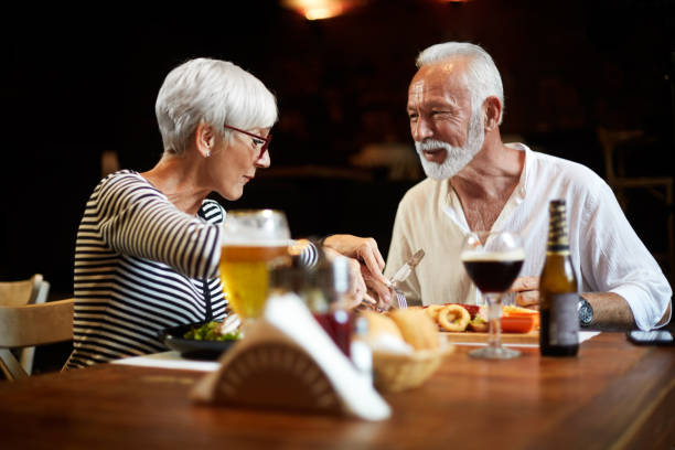 istock Elderly couple having a meal with beer in a restaurant 1085234248