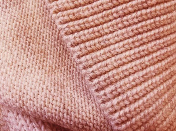 istock Background texture of soft wool, pattern. Pink color. Close-up, selective focus, copy space. 1085243848