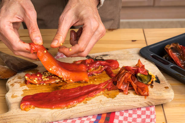 istock Peeling a roasted pepper. Removing skin and seeds with hands 1085244098