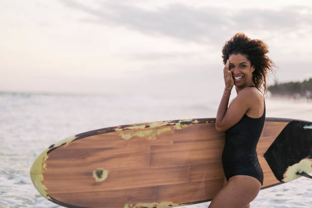 istock Colored girl with surfboard on the beach 1085249216