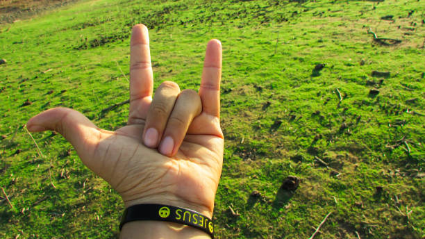 Hand pointing towards the green background landscape