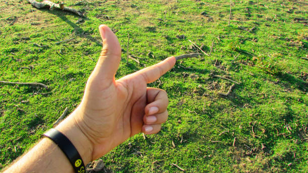 istock Hand pointing towards the green background landscape 1085249326