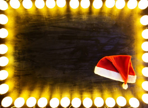 istock Christmas light on black background with santa hat 1085250038