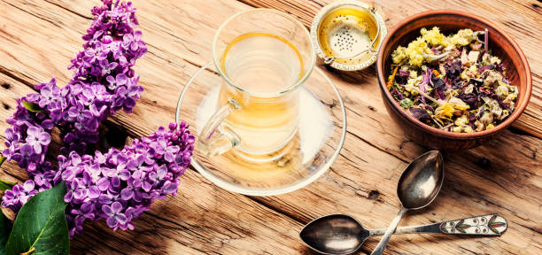 istock Cup of tea and lilac flowers 1085250076