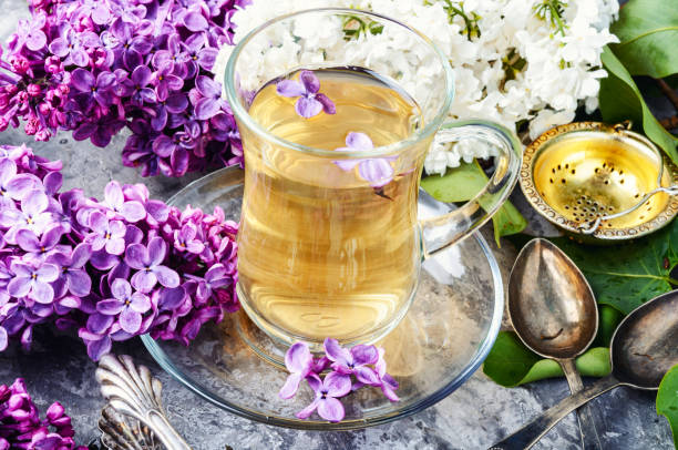 istock Cup of tea and lilac flowers 1085250110
