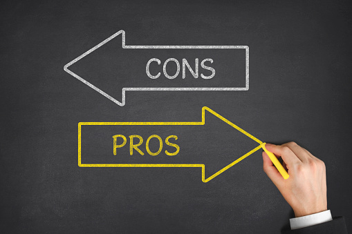 Pros and cons arrows on blackboard