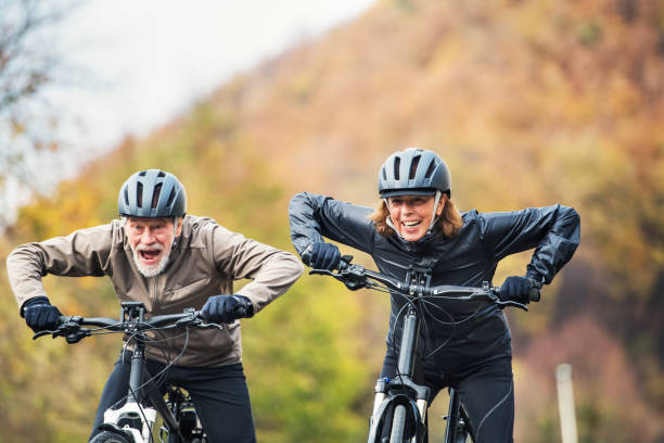 istock Active senior couple with electrobikes cycling outdoors on a road in nature. 1085257164