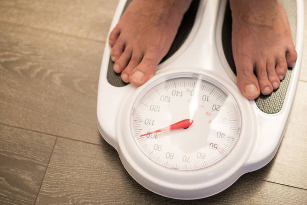 istock Obese or overweight male on weigh scale 1085259850