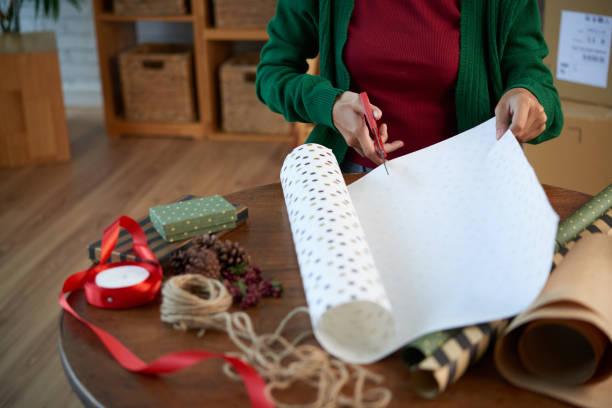 istock Woman cutting off paper to wrap present 1085260420